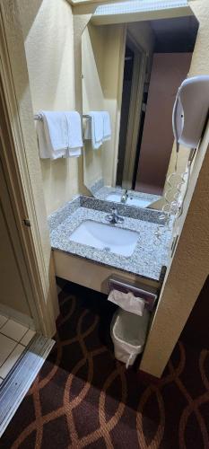 a bathroom with a sink and a toilet at American Inn Evansville East in Evansville