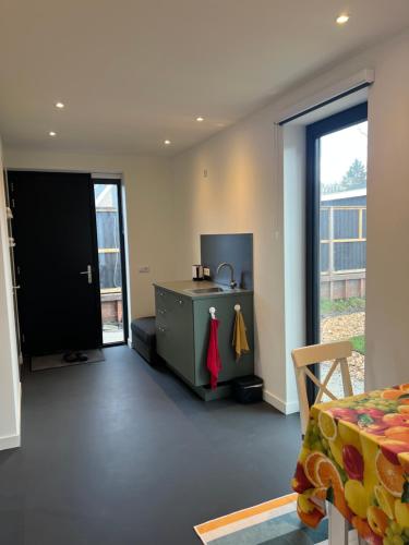a room with a bedroom with a bed and a door at Het Hunebedje in Vries