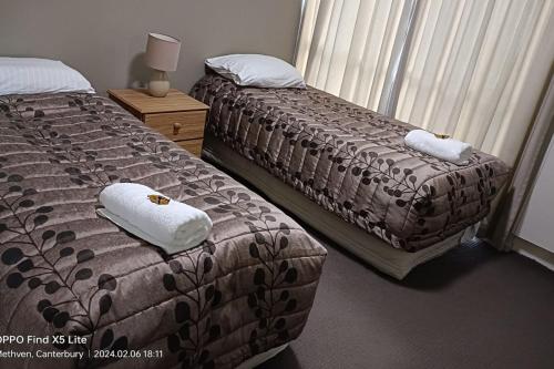 a bedroom with two beds and a window at Mt Hutt Views at 23 Methven in Methven