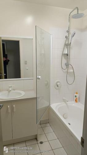 a white bathroom with a shower and a sink at Mt Hutt Views at 23 Methven in Methven