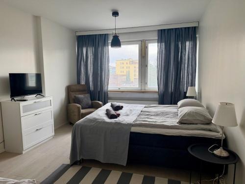 a bedroom with a bed with a cat laying on it at Apartment Kopin5 in Kokkola