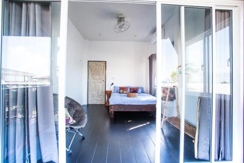 a room with a bedroom with a bed and a window at Sweet Life Guesthouse in Ko Lanta