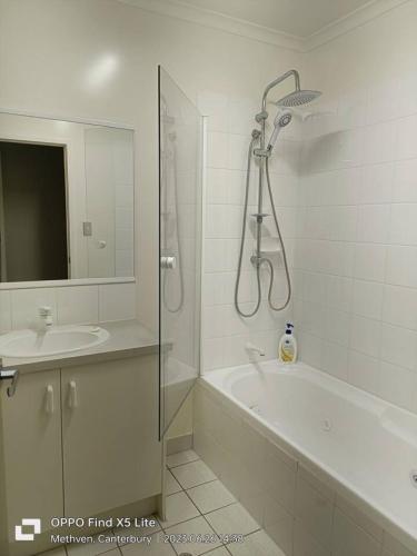 a bathroom with a shower and a tub and a sink at Opuke Crash Pad Methven - with mountain views. in Methven