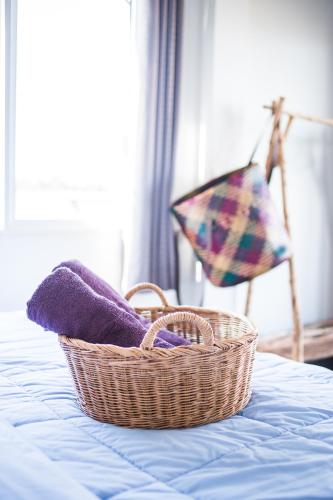 a basket sitting on top of a bed at Sweet Life Guesthouse in Ko Lanta