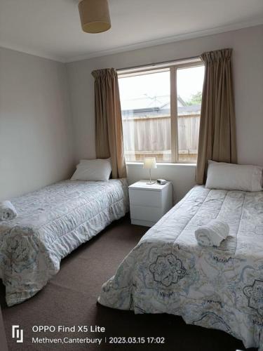 a bedroom with two beds and a window at Methven Crash Pad in Methven