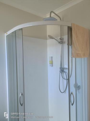 a shower in a bathroom with a glass door at Methven Crash Pad in Methven