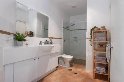 a bathroom with a sink and a toilet and a shower at Oceanfront Oasis in Grange