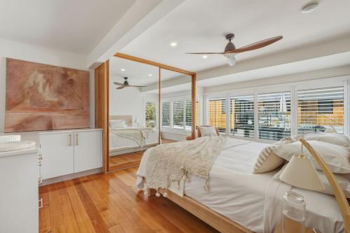 a bedroom with a large bed and a large window at Bunkers at Seven Mile in Seven Mile Beach
