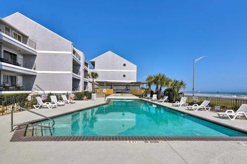a swimming pool in front of a building at Ocean-View Balcony Family Gem on Seawall Blvd! in Galveston