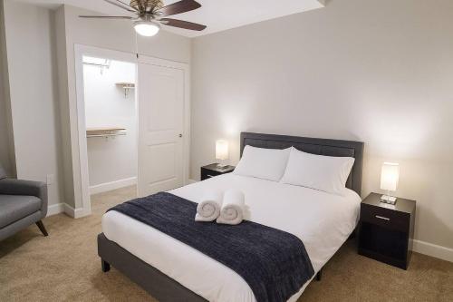 a bedroom with a bed with two towels on it at Cozy Downtown Suite Stadiums, Casino, R&R HoF in Cleveland