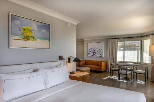 a hotel room with a bed and a living room at The Waterfront Beach Resort, A Hilton Hotel in Huntington Beach