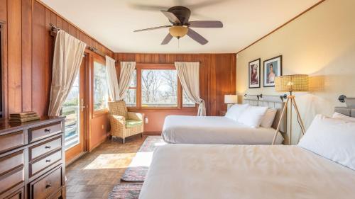 a bedroom with two beds and a ceiling fan at Asher by AvantStay in Asheville