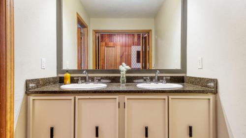 a bathroom with two sinks and a large mirror at Asher by AvantStay in Asheville