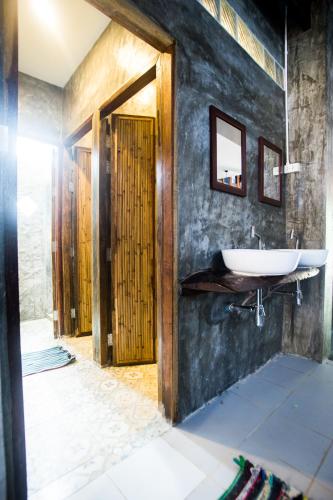 a bathroom with a sink and a mirror at Sweet Life Guesthouse in Ko Lanta