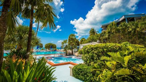 an image of a swimming pool at a resort at Atlantic Paradise by AvantStay Great Location w Balcony Outdoor Dining Shared Pool Hot Tub in Key West