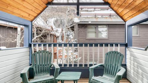 two green chairs sitting on a porch at Smuggler B by AvantStay Excellent Condo Within Walking Distance Of Lift 7 in Telluride