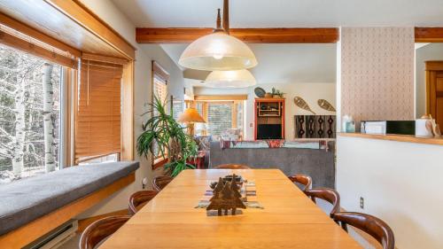 a kitchen and dining room with a wooden table and chairs at Smuggler B by AvantStay Excellent Condo Within Walking Distance Of Lift 7 in Telluride