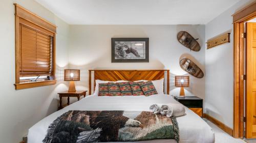 a bedroom with a bed with a dog laying on it at Smuggler B by AvantStay Excellent Condo Within Walking Distance Of Lift 7 in Telluride