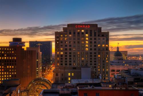 a building with a corazon sign on the top at sunset at Conrad Indianapolis in Indianapolis