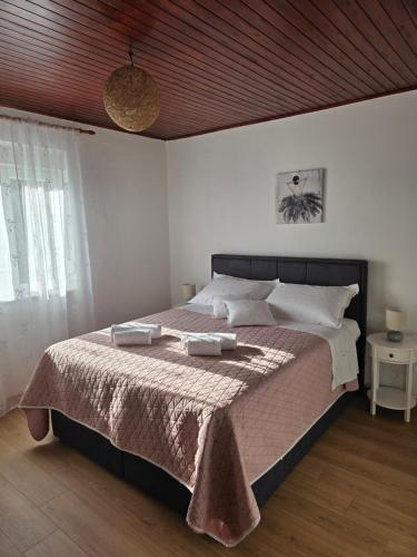 a bedroom with a bed with two towels on it at Kuća za odmor Elena in Vrlika