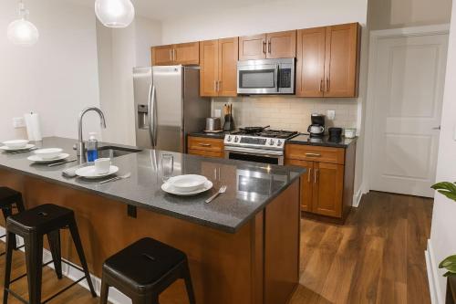 a kitchen with wooden cabinets and a large counter top at Cozy Downtown Suite Stadiums, Casino, R&R HoF in Cleveland