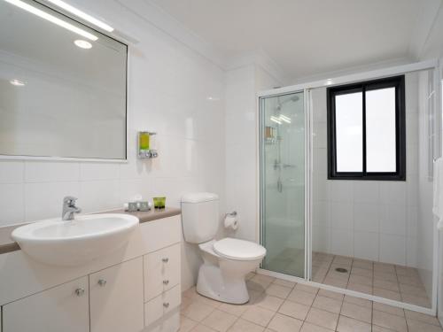 a bathroom with a toilet and a sink and a shower at Leisure Inn Spires in Leura