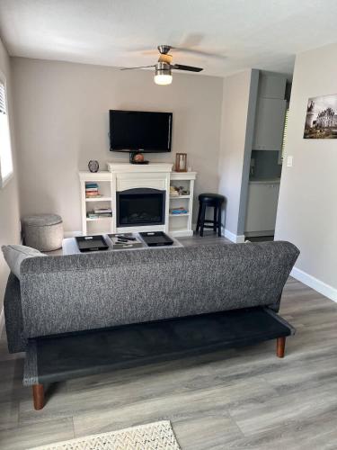 a living room with a couch and a tv at Lake Simcoe Beach Oasis with Backyard and Firepit in Georgina