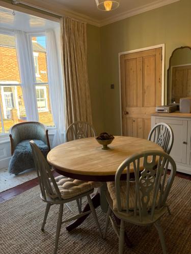 a dining room with a wooden table and chairs at River walk . Shrewsbury.Shropshire.With parking. in Shrewsbury