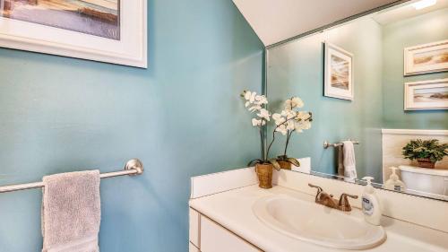 a bathroom with a sink and a mirror at Duval Sea Turtle by AvantStay Great Location Close to Shops Shared Pool in Key West