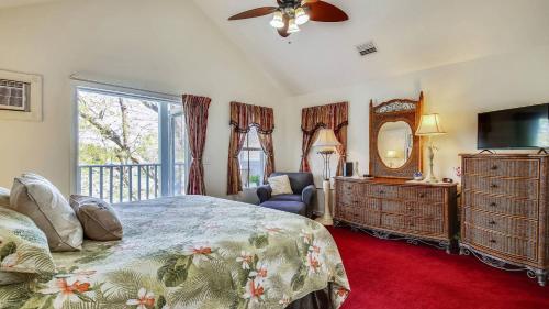 a bedroom with a bed and a dresser and a mirror at Duval Sea Turtle by AvantStay Great Location Close to Shops Shared Pool in Key West