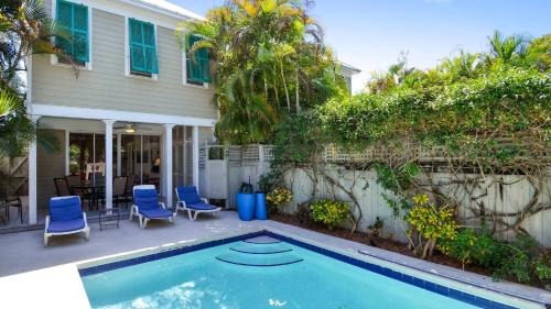 a house with a swimming pool in front of a house at Tropical Dreaming by AvantStay 4 BLKS to Beach Private Pool in Key West