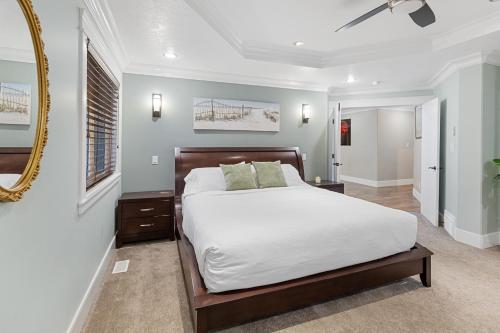 a bedroom with a large bed and a mirror at Hearthside Estate in Prince George