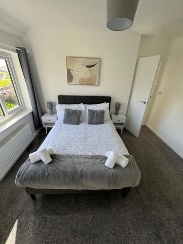a bedroom with a large bed with two pillows at Rowe Terrace Workington in Workington