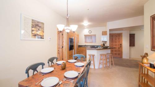 a dining room and kitchen with a table and chairs at Westermere 311 - 2 by AvantStay Just Steps From Ski Area w Great Views in Telluride