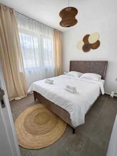 a bedroom with a large bed and a large rug at Kantara Beach Resort Apartment FeMa in Athalassa