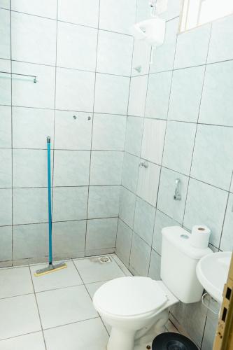 a bathroom with a toilet and a sink at Lagos Hotel in Itajubá
