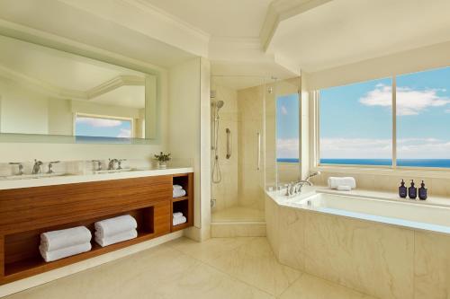 a bathroom with a tub and a large window at Grand Wailea Resort Hotel & Spa, A Waldorf Astoria Resort in Wailea