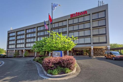 a building with an american flag in front of it at Hilton Knoxville Airport in Alcoa