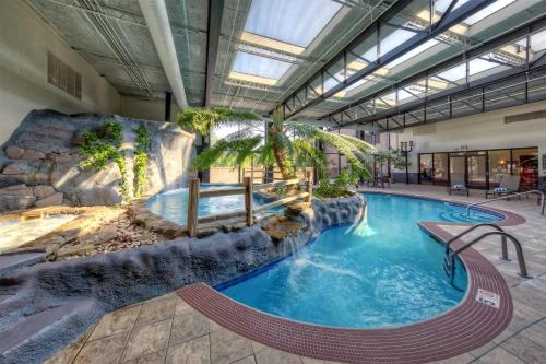 a large pool with a waterfall in a building at Hilton Knoxville Airport in Alcoa