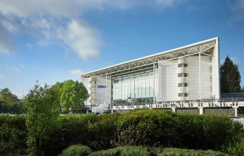 a large white building with a lot of windows at Hilton London Heathrow Airport in Hillingdon