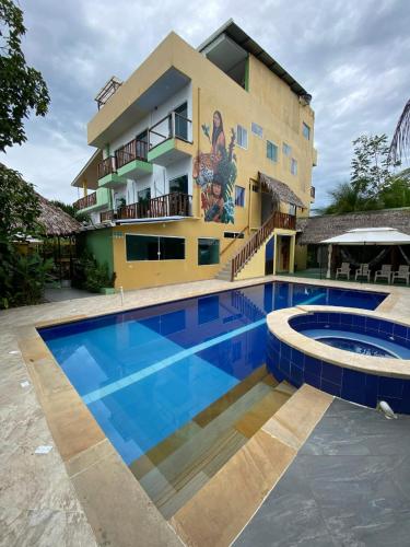 a hotel with a swimming pool in front of a building at Hotel & Restaurante Siami in Leticia