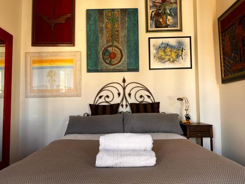 a bedroom with a bed with two towels on it at Beautiful Apartment Teatro Cervantes in Málaga