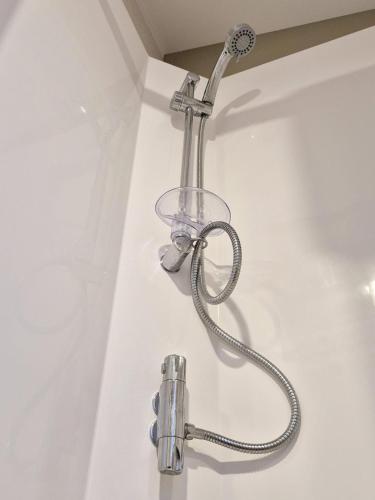a shower head attached to a wall in a bathroom at Whitstable Hollington in Seasalter