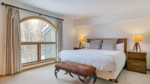 a bedroom with a large bed and a window at Riverside Condos C102 by AvantStay Condo Close To Downtown Town Park Ski Lift 8 in Telluride