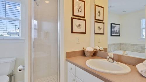 a bathroom with a sink and a shower and a toilet at Coral Villa by AvantStay Close 2 DT Key West Shared Pool Patio in Stock Island