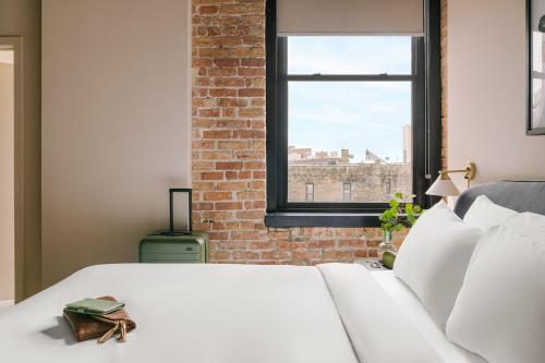 a bedroom with a white bed and a window at LIVN West Loop Chicago Classic Queen Studio in Chicago