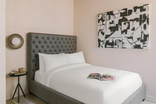 a bedroom with a bed with a book on it at LIVN West Loop Chicago Classic Queen Studio in Chicago