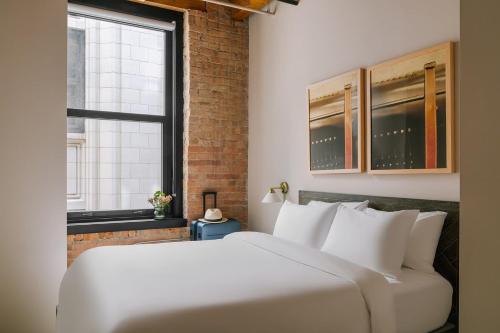 a large white bed in a room with a window at LIVN West Loop Chicago Queen Superior Studio in Chicago