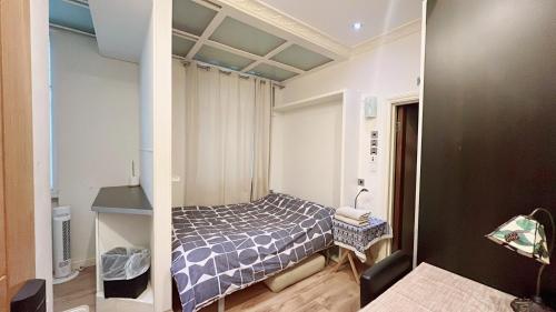 a small bedroom with a bed in a room at Soho China Town Rooms in London