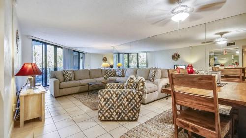 a living room with a couch and a table at Beachfront 2BDR Condo Pool Hot Tub w Ocean Views Papaya Place by AvantStay in Key West